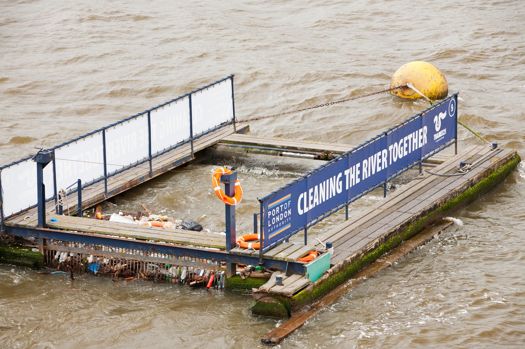 Floating debris-collection system operating in a tidal environment